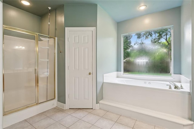full bathroom featuring tile patterned floors, a garden tub, a shower stall, and baseboards