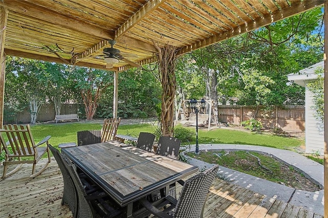 view of patio with outdoor dining space, ceiling fan, a wooden deck, and a fenced backyard