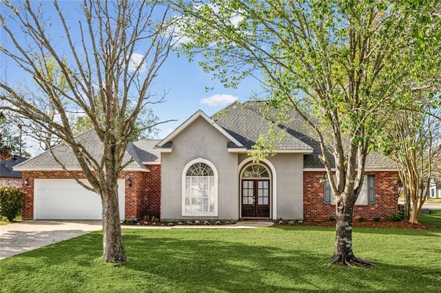 single story home featuring driveway, a front yard, french doors, and an attached garage