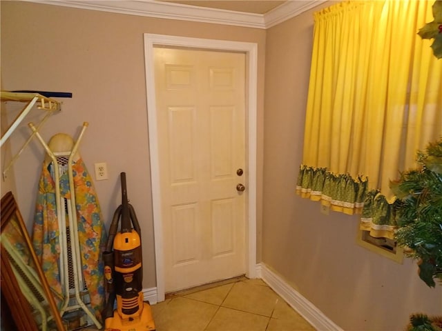 doorway to outside with light tile patterned flooring, baseboards, and ornamental molding
