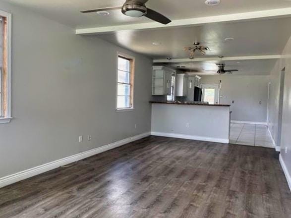 2359 Prentiss Ave, New Orleans, LA 70122 - unfurnished living room with dark wood-type flooring, baseboards, and a ceiling fan