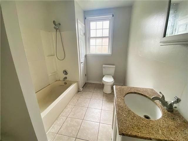 2359 Prentiss Ave, New Orleans, LA 70122 - bathroom featuring vanity, tile patterned flooring, toilet, shower / bath combination, and baseboards