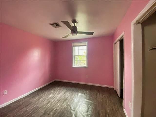 2359 Prentiss Ave, New Orleans, LA 70122 - unfurnished bedroom with ceiling fan, visible vents, baseboards, and dark wood-style floors