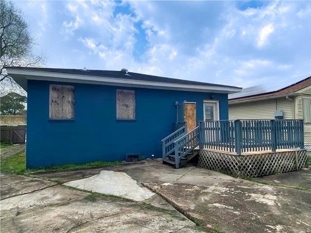 2359 Prentiss Ave, New Orleans, LA 70122 - view of front of house with a wooden deck, fence, and a patio area