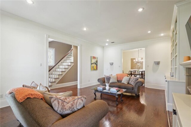3752 Lake Charles Dr, Gretna, LA 70056 - living area with a notable chandelier, dark wood-style flooring, ornamental molding, recessed lighting, and stairs