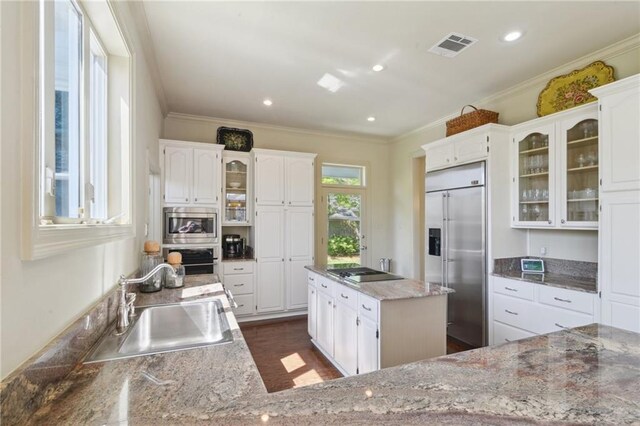 3752 Lake Charles Dr, Gretna, LA 70056 - kitchen with built in appliances, ornamental molding, glass insert cabinets, white cabinets, and a sink
