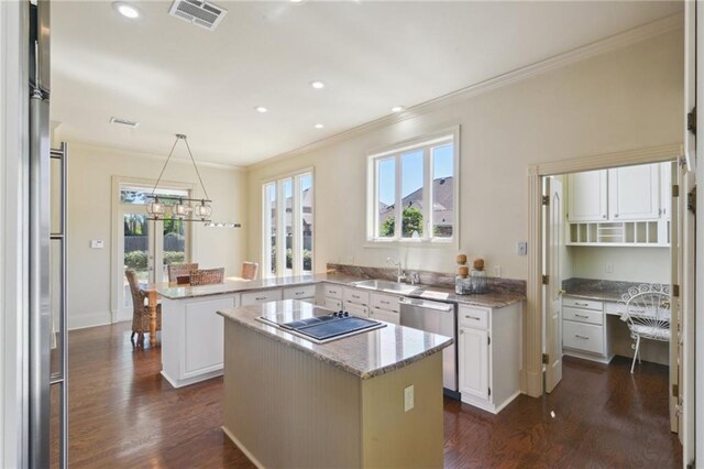 3752 Lake Charles Dr, Gretna, LA 70056 - kitchen with appliances with stainless steel finishes, ornamental molding, visible vents, and a healthy amount of sunlight