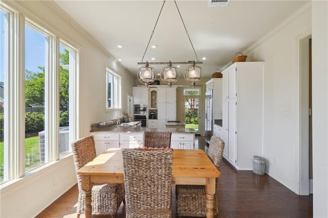 3752 Lake Charles Dr, Gretna, LA 70056 - dining area featuring a wealth of natural light, dark wood-style flooring, and ornamental molding