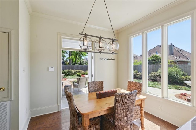 3752 Lake Charles Dr, Gretna, LA 70056 - dining area with dark wood-type flooring, ornamental molding, baseboards, and a chandelier