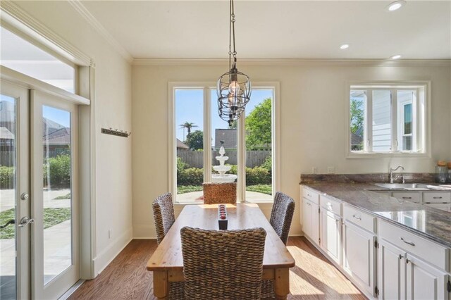 3752 Lake Charles Dr, Gretna, LA 70056 - dining area with ornamental molding, a wealth of natural light, light wood finished floors, and baseboards