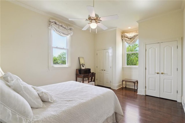 3752 Lake Charles Dr, Gretna, LA 70056 - bedroom featuring crown molding, ceiling fan, dark wood-type flooring, multiple closets, and baseboards