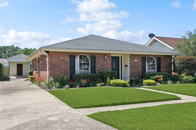 ranch-style house with brick siding, a shingled roof, a front lawn, and concrete driveway