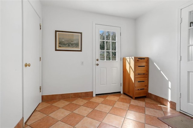 doorway to outside featuring baseboards
