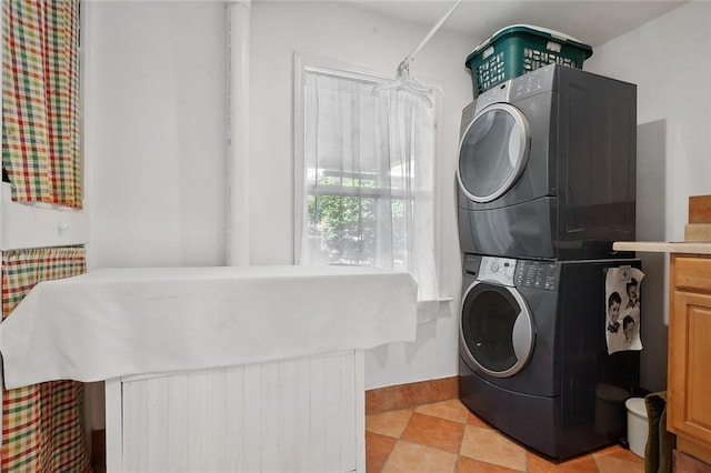washroom featuring stacked washer / drying machine and laundry area