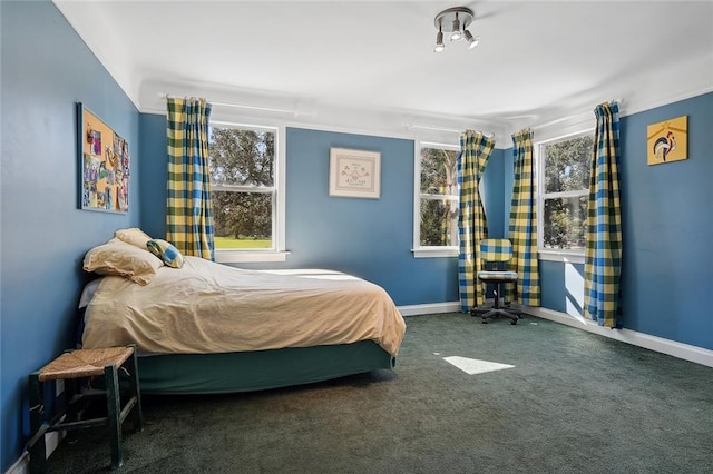 carpeted bedroom featuring baseboards