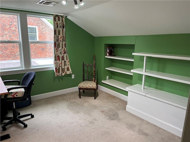 carpeted home office with lofted ceiling, visible vents, and baseboards