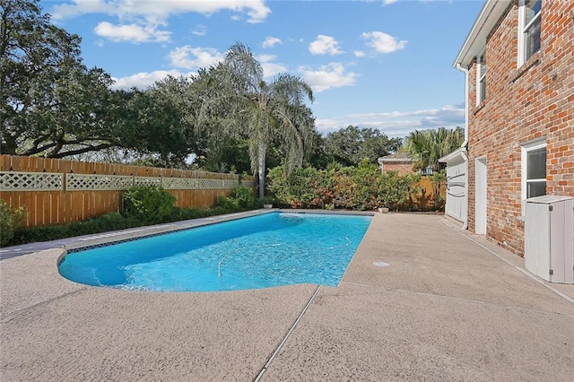 view of swimming pool featuring a fenced in pool, a patio area, and a fenced backyard