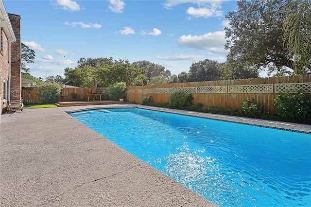 view of swimming pool featuring a fenced backyard, a patio area, and a fenced in pool