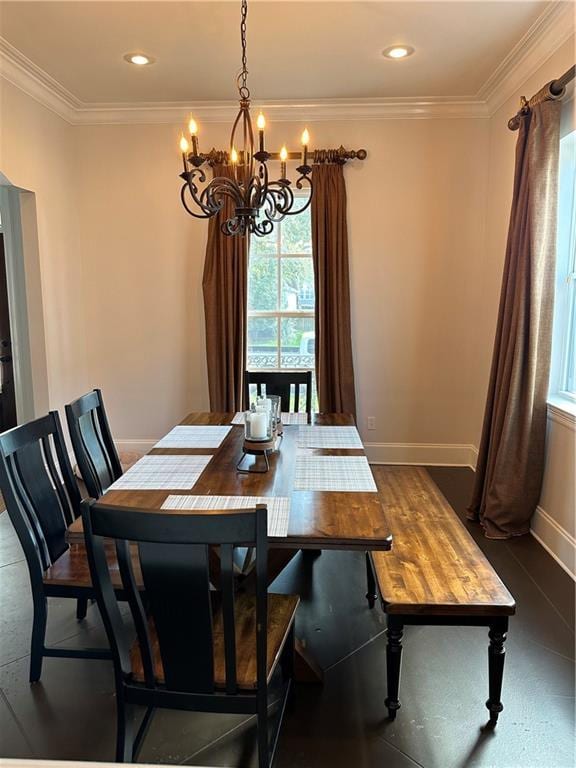 dining room with crown molding, baseboards, a chandelier, and a wealth of natural light