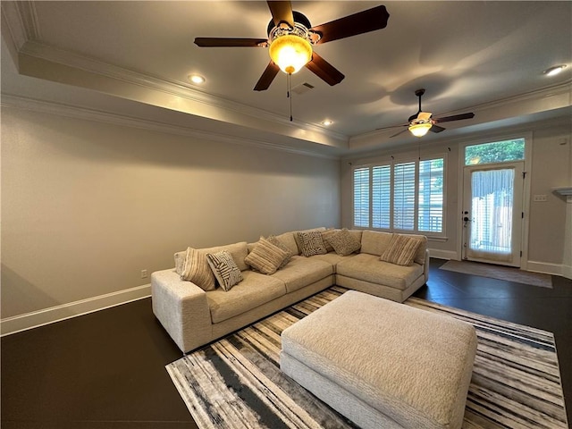 living area featuring a ceiling fan, baseboards, ornamental molding, a tray ceiling, and recessed lighting