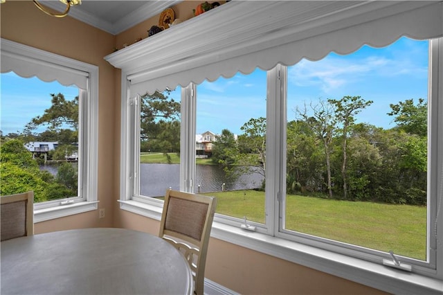 sunroom / solarium featuring a water view