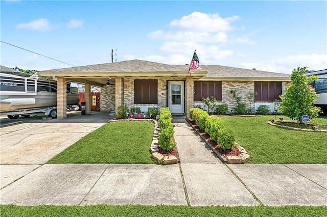 2101 Congressman Hebert Dr, Chalmette, LA 70043 - single story home featuring brick siding, a front lawn, a carport, and driveway