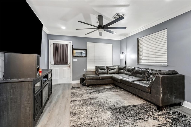 2101 Congressman Hebert Dr, Chalmette, LA 70043 - living room featuring crown molding, a ceiling fan, visible vents, light wood finished floors, and baseboards