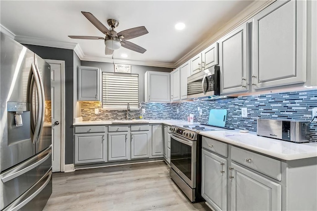 2101 Congressman Hebert Dr, Chalmette, LA 70043 - kitchen featuring crown molding, a ceiling fan, appliances with stainless steel finishes, a sink, and gray cabinetry