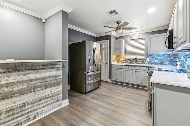 2101 Congressman Hebert Dr, Chalmette, LA 70043 - kitchen featuring a ceiling fan, visible vents, light countertops, stainless steel appliances, and gray cabinetry