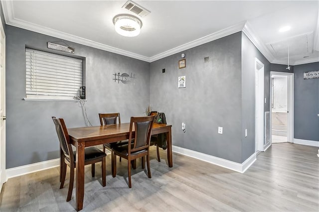 2101 Congressman Hebert Dr, Chalmette, LA 70043 - dining room featuring visible vents, light wood-type flooring, attic access, and ornamental molding