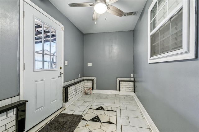 2101 Congressman Hebert Dr, Chalmette, LA 70043 - doorway to outside with visible vents, baseboards, and ceiling fan