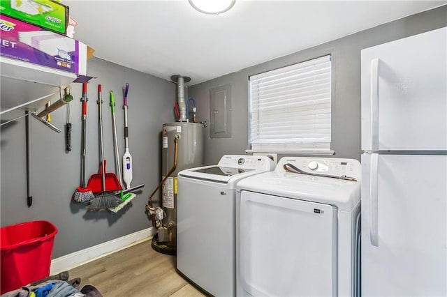 2101 Congressman Hebert Dr, Chalmette, LA 70043 - washroom featuring washer and dryer, electric panel, laundry area, light wood-style floors, and water heater