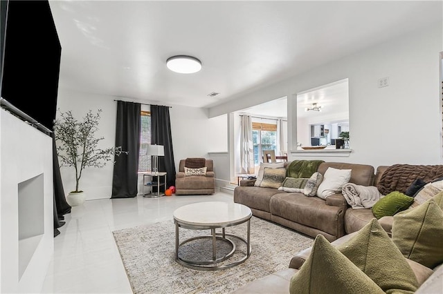 living area featuring visible vents and tile patterned flooring