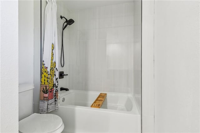 bathroom with toilet and bathing tub / shower combination
