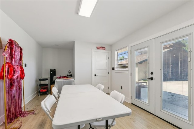 dining room with light wood-style flooring and baseboards