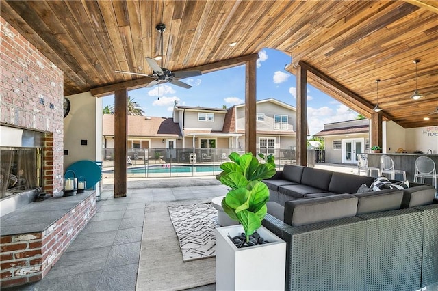 view of patio / terrace featuring ceiling fan, outdoor lounge area, outdoor dry bar, fence, and a fenced in pool