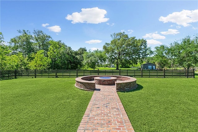 view of yard featuring fence and a fire pit