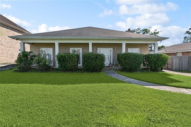 3011 Memorial Park Dr, New Orleans, LA 70114 - view of front of house featuring stucco siding, fence, and a front lawn