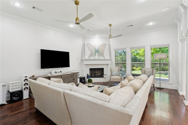 809 S Corniche Du Lac, Covington, LA 70433 - living area with a brick fireplace, crown molding, ceiling fan, dark wood-style flooring, and recessed lighting