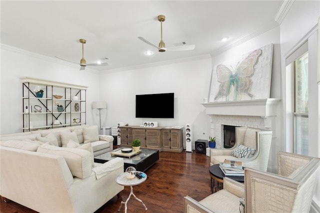 809 S Corniche Du Lac, Covington, LA 70433 - living room featuring crown molding, a ceiling fan, dark wood-style flooring, a brick fireplace, and recessed lighting