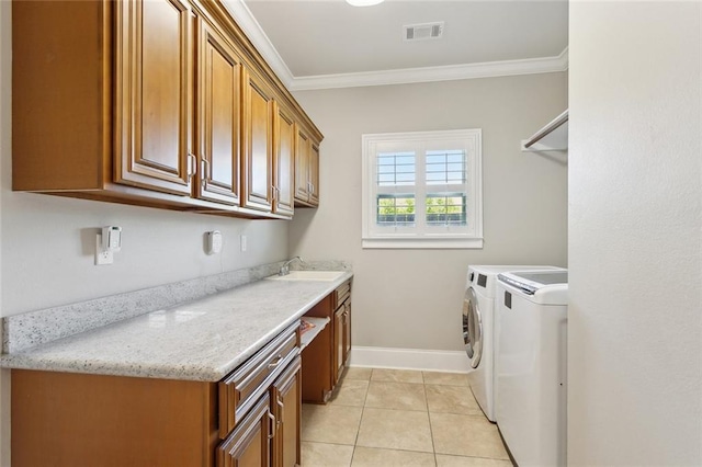 809 S Corniche Du Lac, Covington, LA 70433 - laundry area with cabinet space, washing machine and dryer, crown molding, and light tile patterned flooring