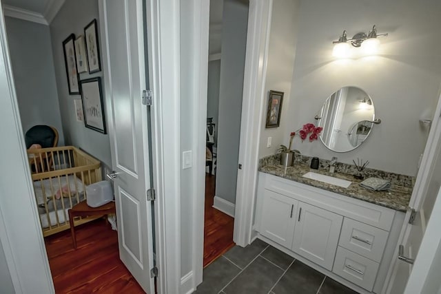 bathroom featuring ornamental molding, vanity, and tile patterned flooring