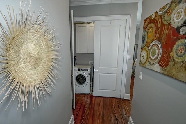washroom with washer / clothes dryer, dark wood-style flooring, baseboards, and cabinet space