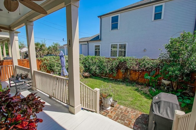 view of patio / terrace with a ceiling fan, fence, and area for grilling