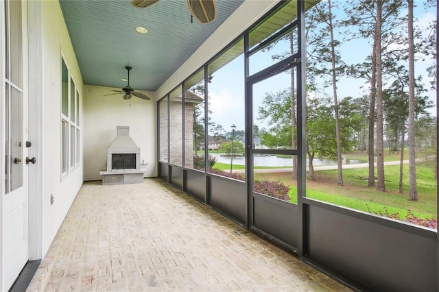 unfurnished sunroom featuring ceiling fan