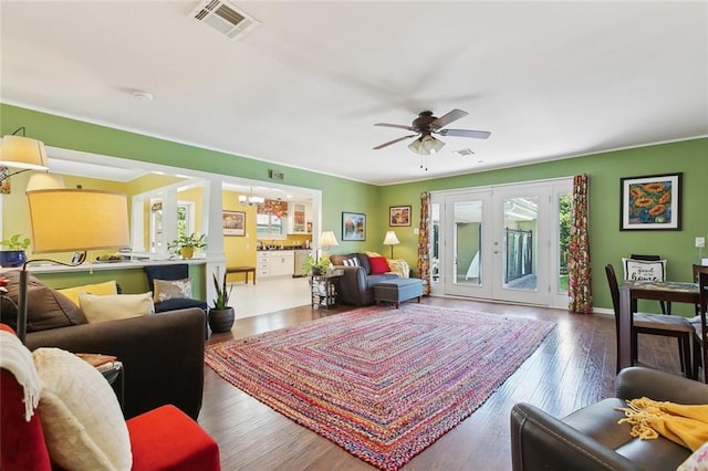 3000 Clifford Dr, Metairie, LA 70002 - living room featuring french doors, wood finished floors, ceiling fan with notable chandelier, and visible vents