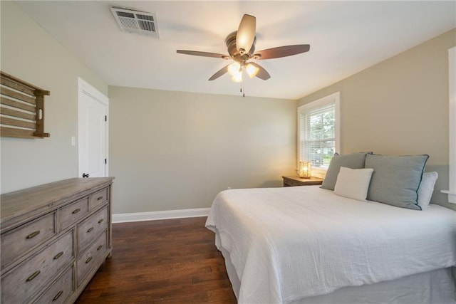 bedroom with dark wood finished floors, baseboards, and a ceiling fan