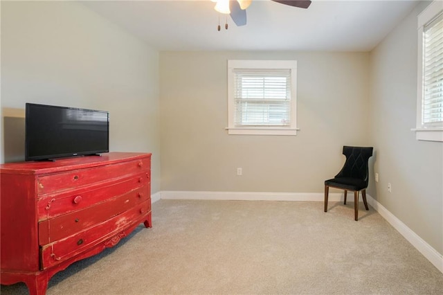 living area featuring ceiling fan, carpet, and baseboards