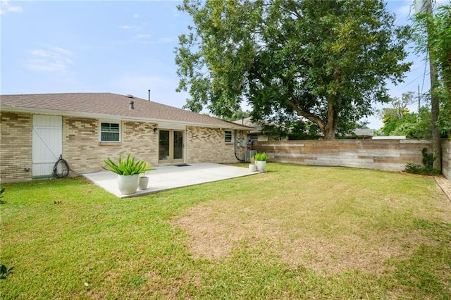 rear view of property with a patio and brick siding