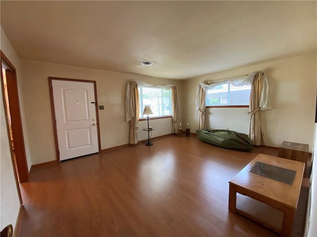 entryway featuring visible vents, wood finished floors, and baseboards
